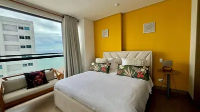 a bedroom with a bed and a large window at Luxury Murano Cartagena Condo in Cartagena de Indias