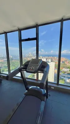 a gym with a treadmill in front of a large window at Luxury Murano Cartagena Condo in Cartagena de Indias