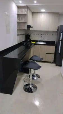 a kitchen with a counter and two stools in it at CARTAGENA CONFORT APARTAMENTO NUEVO y COMPLETO in Cartagena de Indias