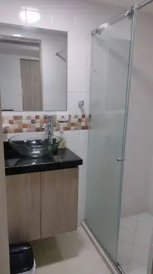 a bathroom with a sink and a glass shower at CARTAGENA CONFORT APARTAMENTO NUEVO y COMPLETO in Cartagena de Indias