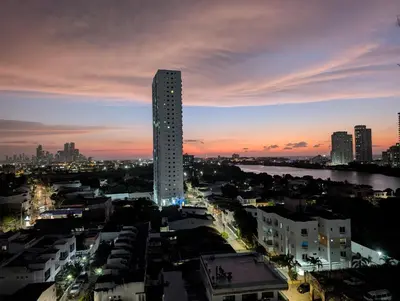a tall building in a city at night at Apartamento con 3 habitaciones y Vista al Mar in Cartagena de Indias