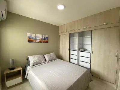 a bedroom with a white bed and a cabinet at Apartamento con 3 habitaciones y Vista al Mar in Cartagena de Indias