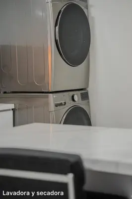 a kitchen with a stove and a microwave at lujoso apartamento familiar frente al mar in Cartagena de Indias