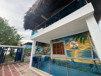 a building with a mural on the side of it at Cabaña Sol y Mar 2 in Coveñas