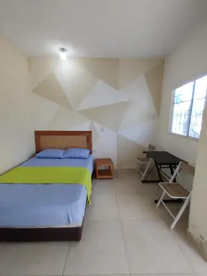 a bedroom with a bed and a desk in it at casa Marez in Cartagena de Indias
