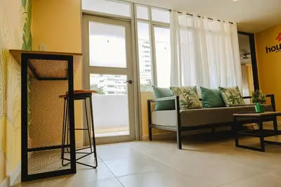 a living room with a couch and a window at Laguito Houstel Large in Cartagena de Indias
