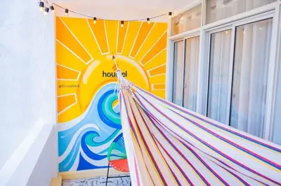 a hammock in a room with a mural at Laguito Houstel Large in Cartagena de Indias