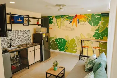 a living room with a kitchen and a living room with a kitchen at Laguito Houstel Large in Cartagena de Indias