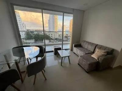 a living room with a couch and a glass table at Apto playa Alojamiento en Cartagena in Cartagena de Indias