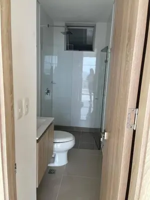 a bathroom with a toilet and a glass shower at Apto playa Alojamiento en Cartagena in Cartagena de Indias