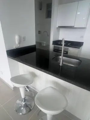 a kitchen counter with two stools and a sink at Apto playa Alojamiento en Cartagena in Cartagena de Indias