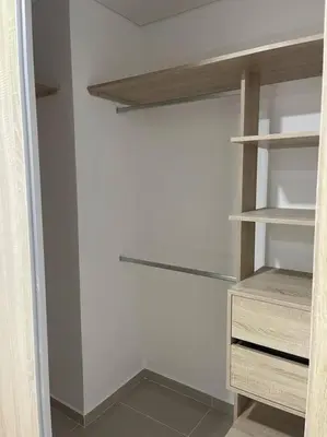 a closet with wooden shelves and a white wall at Apto playa Alojamiento en Cartagena in Cartagena de Indias