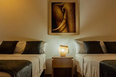 a room with two beds and a picture of an elephant at APARTAMENTO EN CARTAGENA CON SALiDA DIRECTA A LA PLAYA in Cartagena de Indias