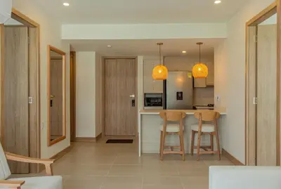 a kitchen with two chairs and a table in a room at APARTAMENTO EN CARTAGENA CON SALiDA DIRECTA A LA PLAYA in Cartagena de Indias