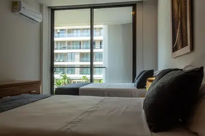 a hotel room with two beds and a large window at APARTAMENTO EN CARTAGENA CON SALiDA DIRECTA A LA PLAYA in Cartagena de Indias