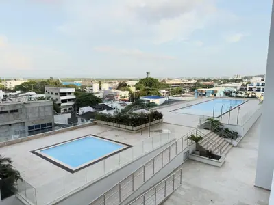 an apartment with two pools on the roof of a building at Apartamento suite Cartagena - Cartagena Beach Resort in Cartagena de Indias