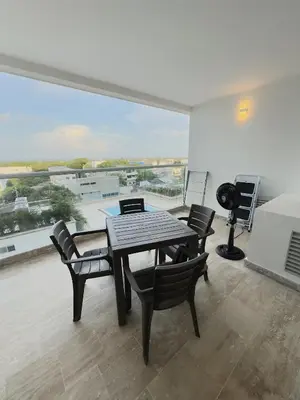 a dining room with a table and chairs and a large window at Apartamento suite Cartagena - Cartagena Beach Resort in Cartagena de Indias