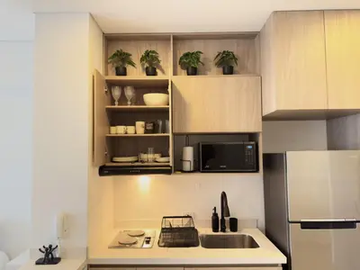 a kitchen with a sink and a microwave at Apartamento suite Cartagena - Cartagena Beach Resort in Cartagena de Indias