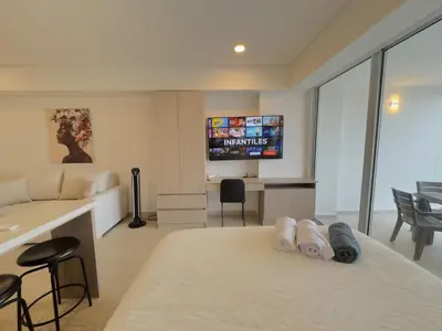 a hotel room with a bed and a tv at Apartamento suite Cartagena - Cartagena Beach Resort in Cartagena de Indias