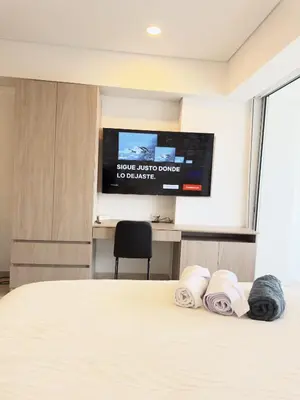 a bedroom with a bed and a flat screen tv at Apartamento suite Cartagena - Cartagena Beach Resort in Cartagena de Indias