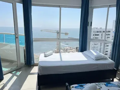 a bedroom with a bed and a view of the ocean at Apartamento con vista al mar in Cartagena de Indias