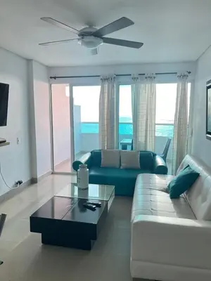 a living room with a couch and a ceiling fan at Apartamento con vista al mar in Cartagena de Indias