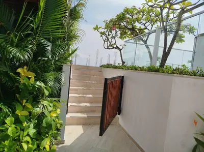 a stairway with a wooden door and some plants at Cartagena Martinique - Hermoso apartamento con Jacuzzi en el Balcón! in Cartagena de Indias