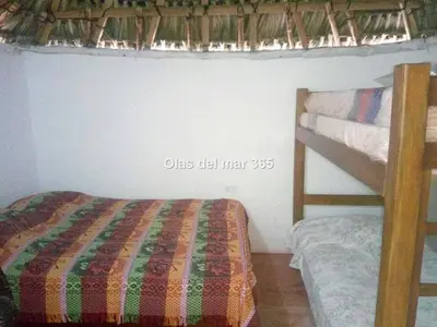a bedroom with a bunk bed next to a bunk bed gmaxwell gmaxwell gmaxwell at Cabaña Olas Del Mar in San Bernardo del Viento