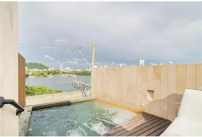 a plunge pool with a view of a body of water at Sunny new apt in the Old City in Cartagena de Indias