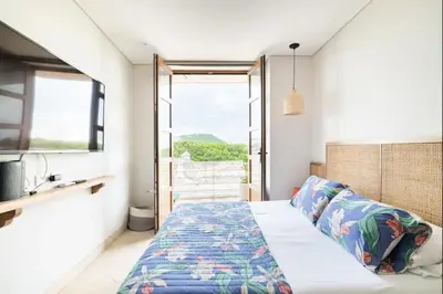 a bedroom with a bed and a window at Sunny new apt in the Old City in Cartagena de Indias
