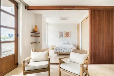 a bedroom with two chairs and a bed at Sunny new apt in the Old City in Cartagena de Indias