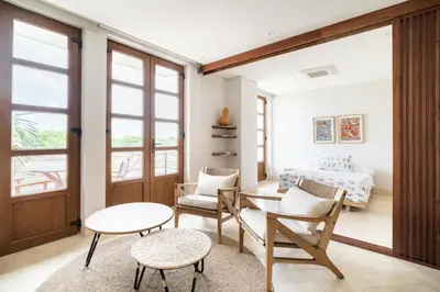 a bedroom with a bed and a table and chairs at Sunny new apt in the Old City in Cartagena de Indias