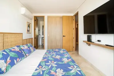 a bedroom with a bed and a flat screen tv at Sunny new apt in the Old City in Cartagena de Indias