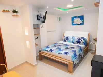 a small bedroom with a bed in a room at Studio Nurita Boston in Barranquilla