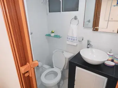 a bathroom with a toilet and a sink at Studio Nurita Boston in Barranquilla