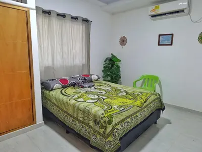 a bedroom with a bed in a room with a window at Apartamento sereno, cerca al mar in El Porvenir