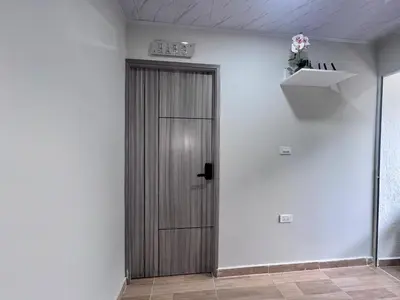 a hallway with a wooden door in a room at Hospedaje Casa Rueda in Barranquilla