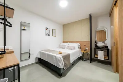 a bedroom with a bed and a mirror at Casa Gracia Hotel Boutique in Cartagena de Indias