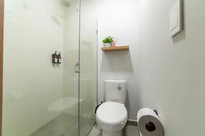 a bathroom with a toilet and a glass shower at Casa Gracia Hotel Boutique in Cartagena de Indias
