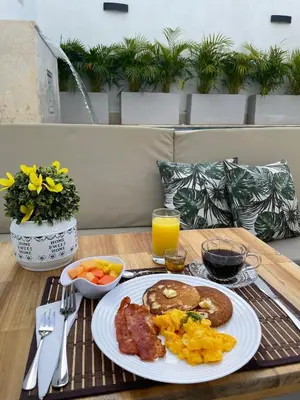 a plate of breakfast food on a table at Casa Gracia Hotel Boutique in Cartagena de Indias
