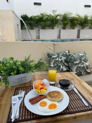 a breakfast plate with eggs and fruit on a table at Casa Gracia Hotel Boutique in Cartagena de Indias
