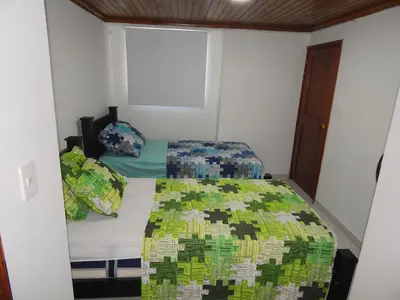 a small bedroom with a bed and a window at Apartment Nurita Boston in Barranquilla