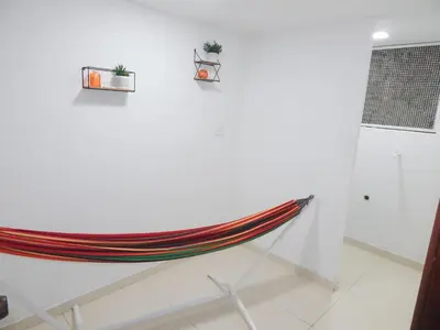 a hammock hanging on a wall in a room at Apartment Nurita Boston in Barranquilla