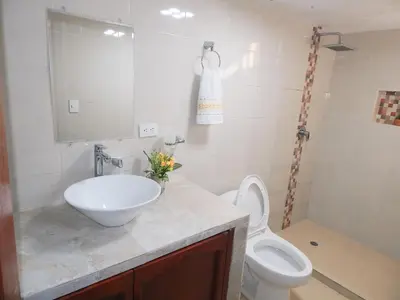 a bathroom with a sink and a toilet at Apartment Nurita Boston in Barranquilla