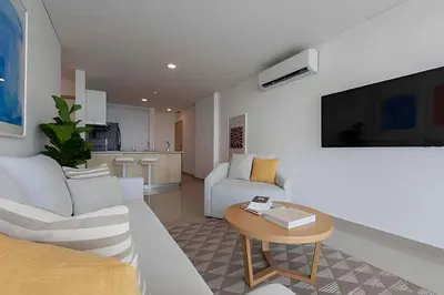 a living room with a white couch and a table at Modern 2BR next to the Walled City+Oceanside View in Cartagena de Indias