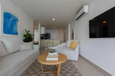 a living room with a white couch and a table at Modern 2BR next to the Walled City+Oceanside View in Cartagena de Indias