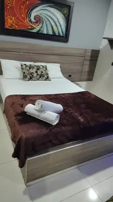 a bed with two towels on top of it at Los Prados Vip in Barranquilla