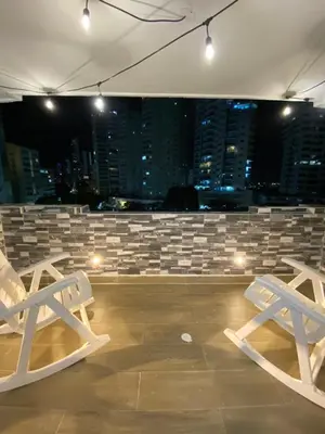 two white chairs in a room with a city skyline at LIVING CARTAGENA Apto de lujo in Cartagena de Indias