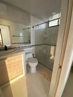 a bathroom with a toilet and a glass shower at LIVING CARTAGENA Apto de lujo in Cartagena de Indias