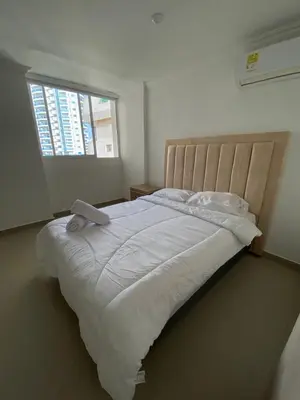 a bedroom with a large white bed with a window at LIVING CARTAGENA Apto de lujo in Cartagena de Indias